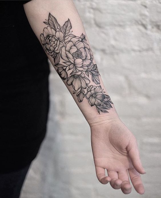 Women Tattoo - Trinity has a sleeve covering her right arm. The sleeve